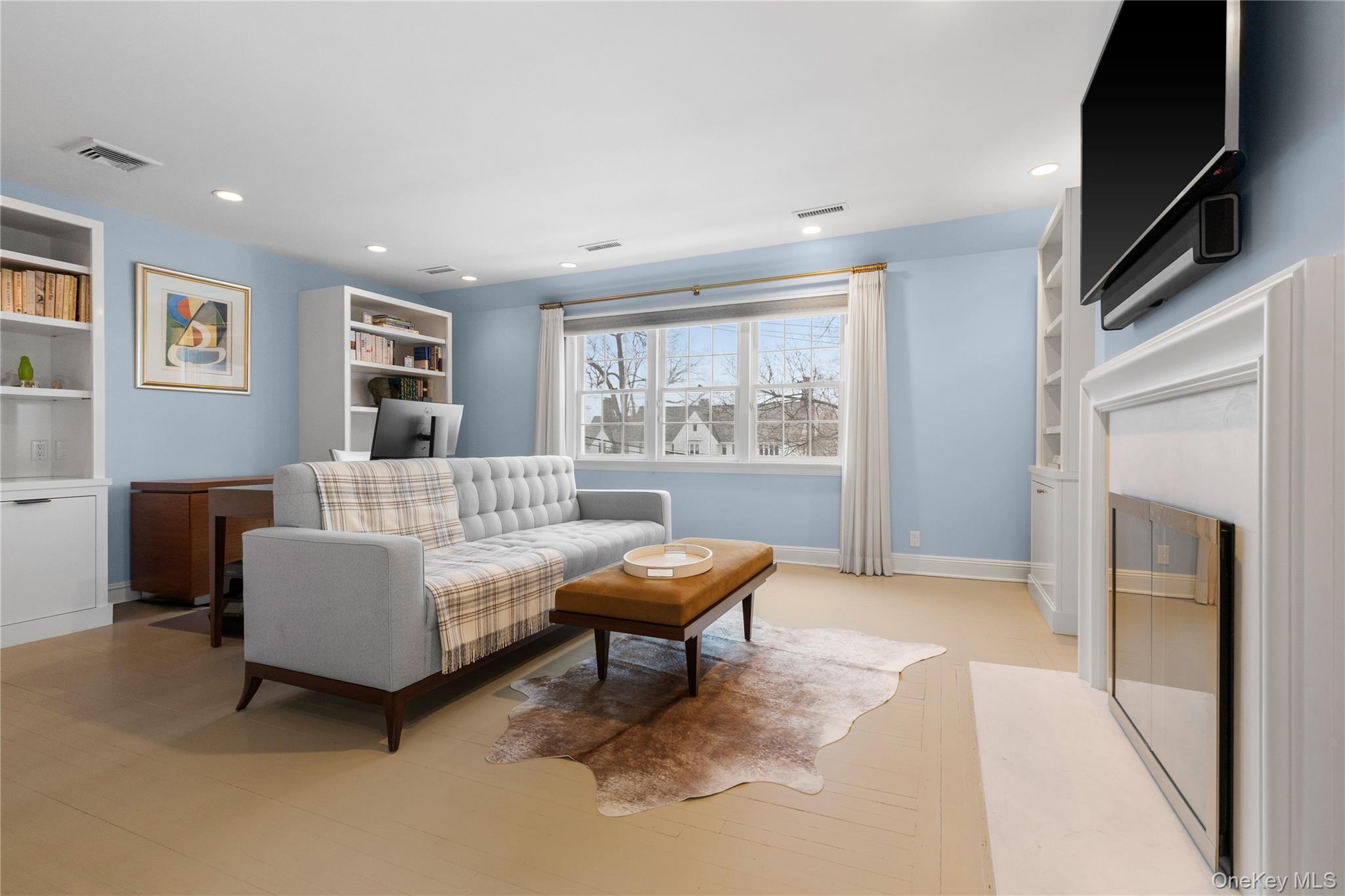 25 Stratford Road Harrison, NY 10528 - Photo 29 of 47 a living room with furniture and a fireplace