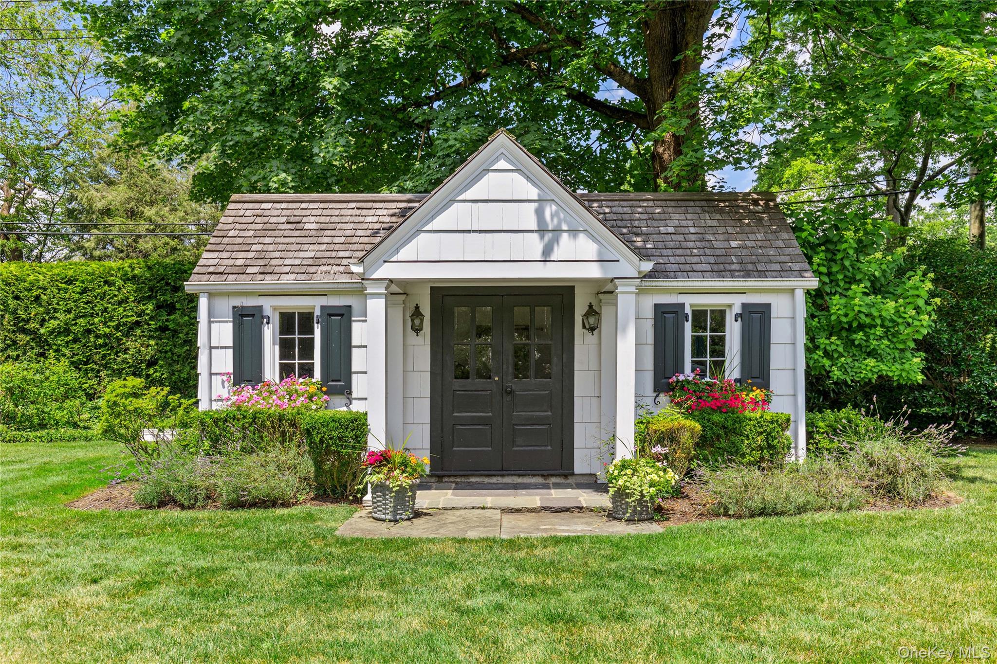25 Stratford Road Harrison, NY 10528 - Photo 40 of 47 a front view of a house with a yard and garage