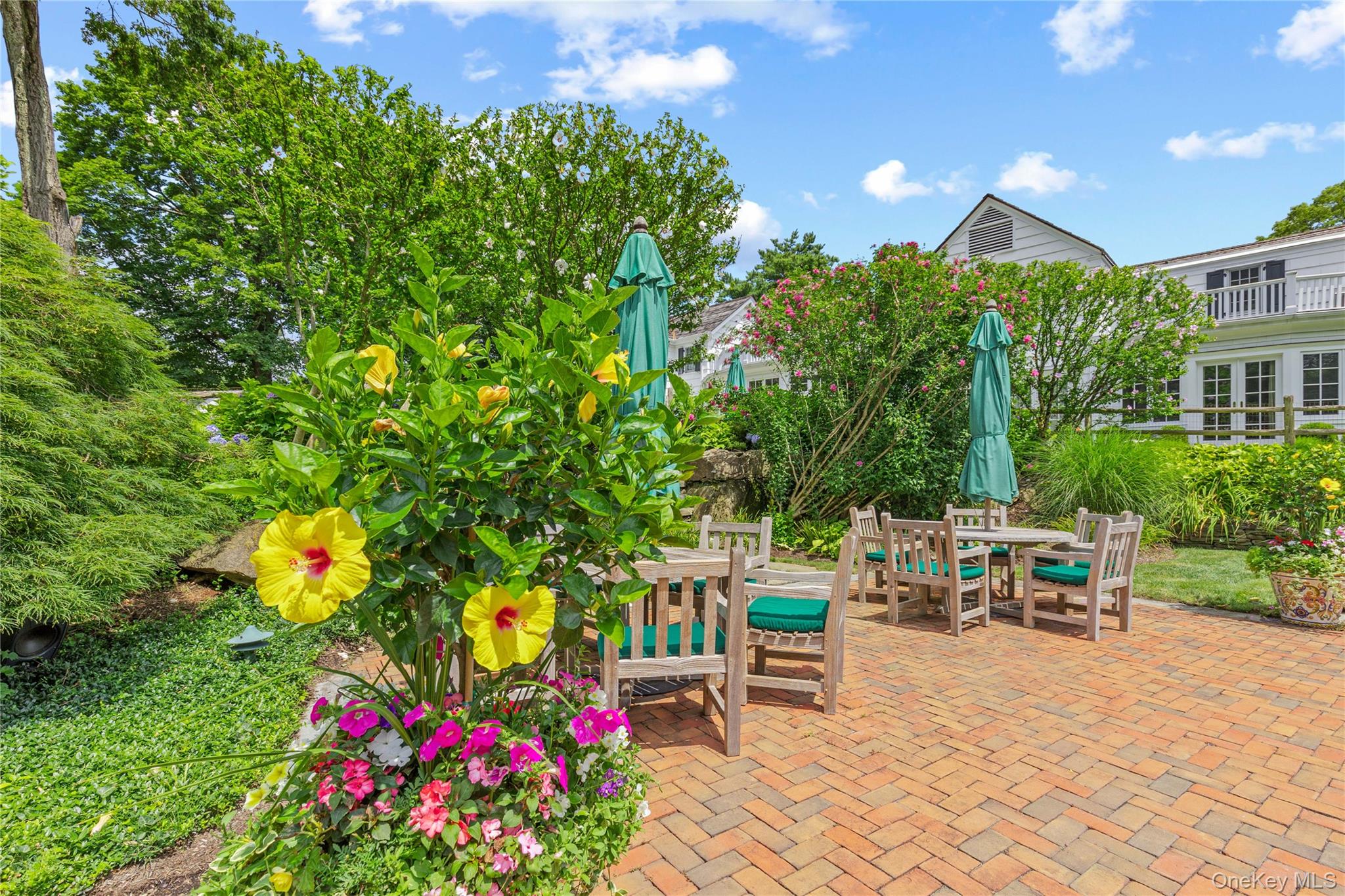 25 Stratford Road Harrison, NY 10528 - Photo 42 of 47 a view of a patio with table and chairs and potted plants