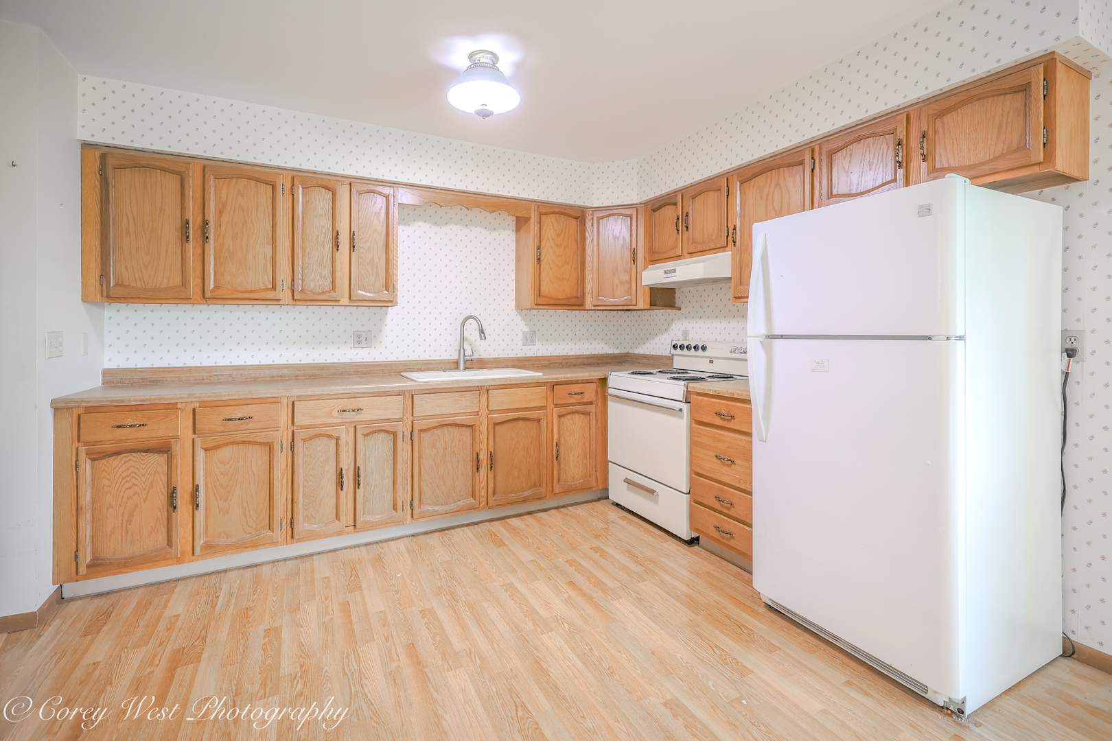 335 South Hadsall Street Genoa, IL 60135 - Photo 9 of 23 a kitchen with white cabinets and white appliances