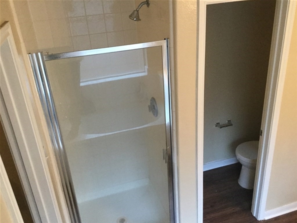 23511 Hidden Maple Drive Spring, TX 77373 - Photo 11 of 18 a bathroom with a granite countertop shower and a toilet