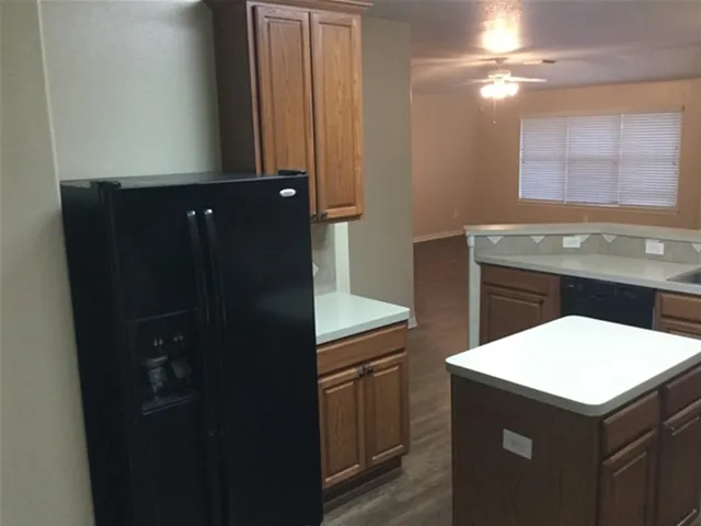 a kitchen with a refrigerator and cabinets