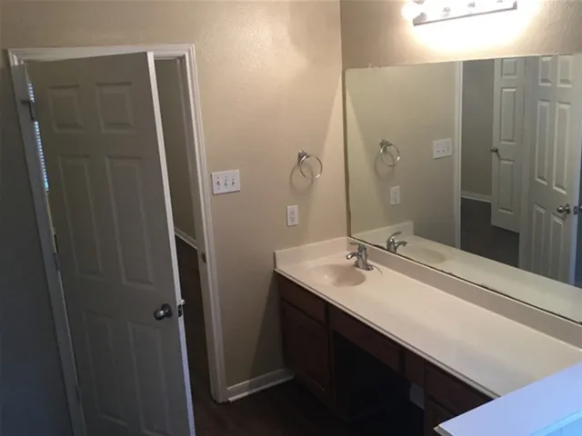 a bathroom with a sink a mirror and a shower
