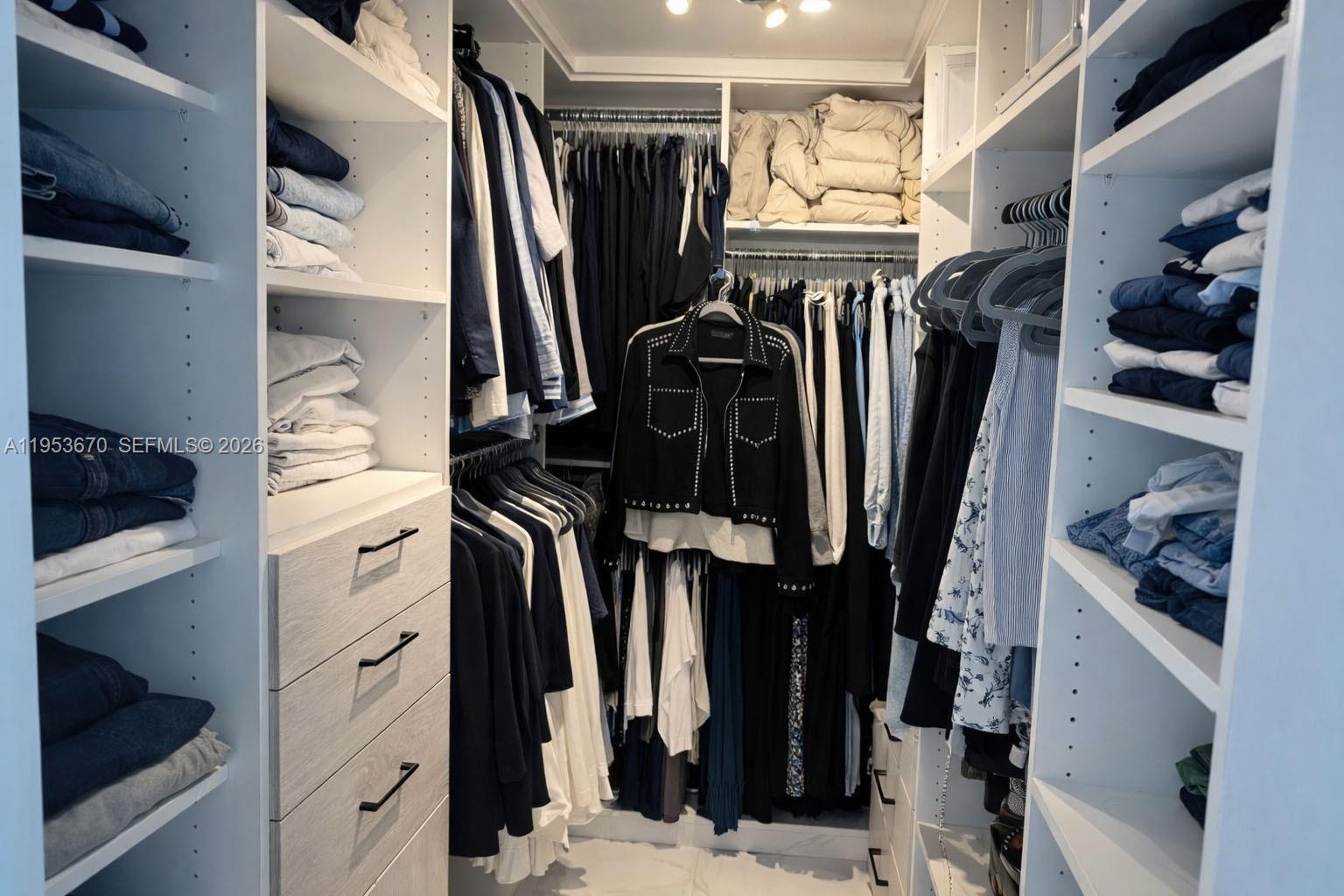 951 Brickell Avenue, Unit 3304 Miami, FL 33131 - Photo 11 of 28 a view of walk in closet with clothes and shoes