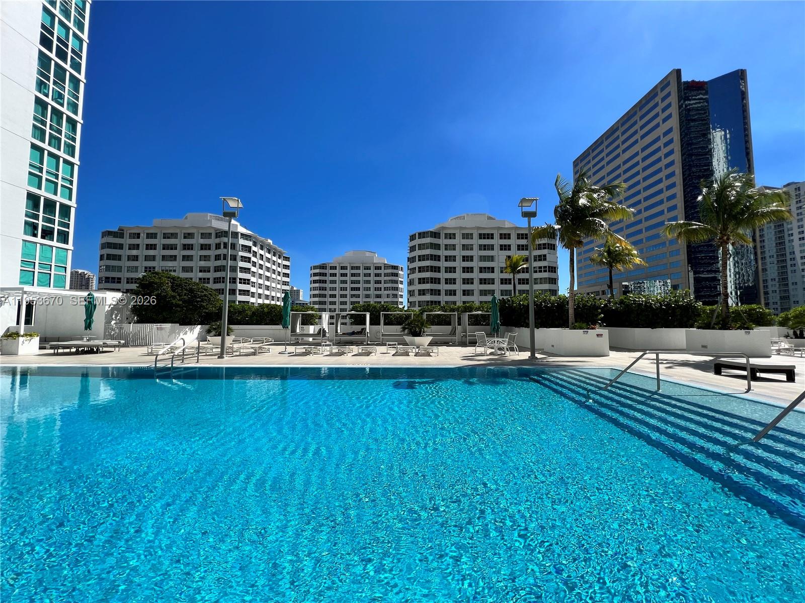 951 Brickell Avenue, Unit 3304 Miami, FL 33131 - Photo 17 of 28 a view of swimming pool with outdoor seating and plants
