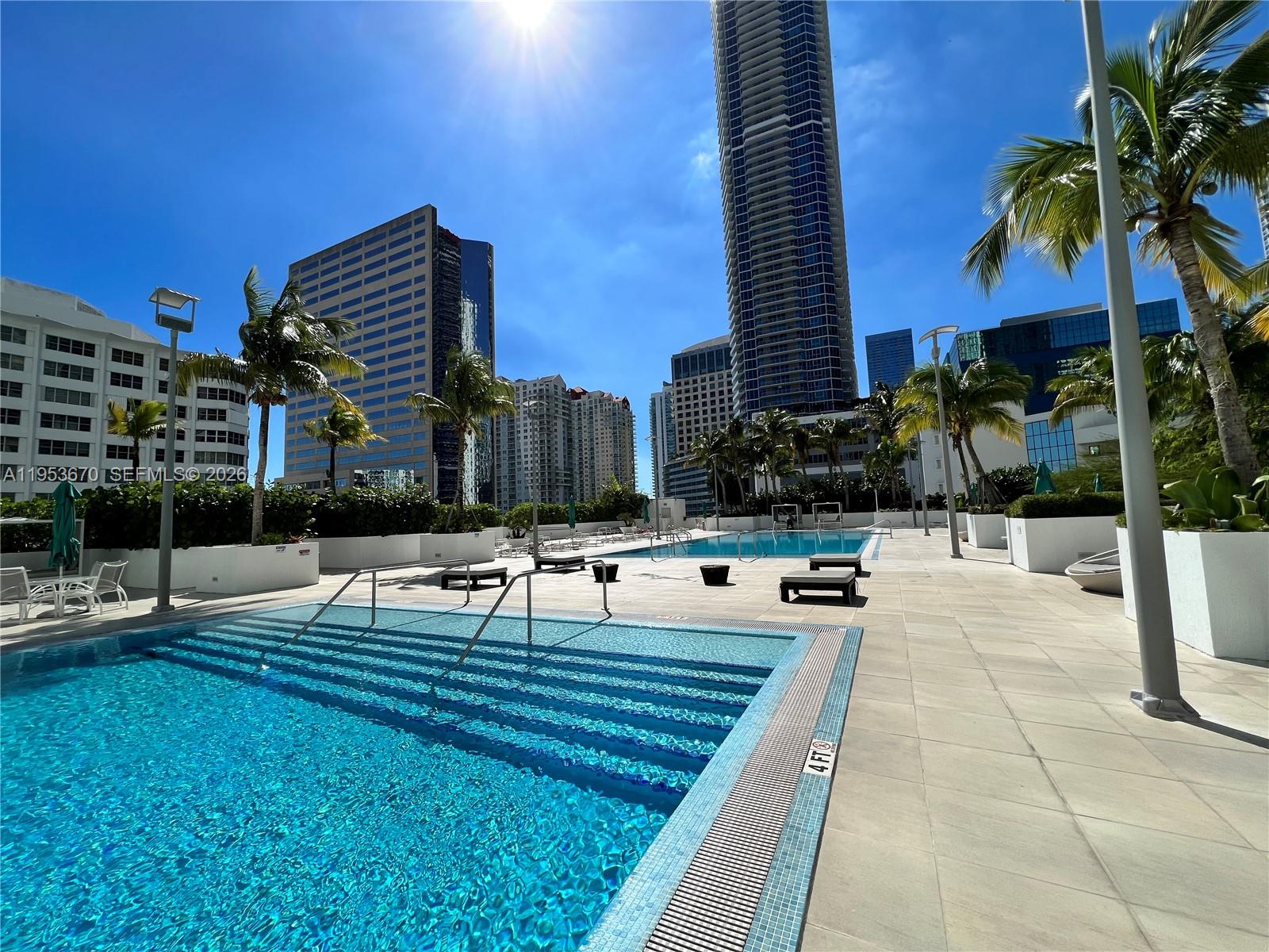 951 Brickell Avenue, Unit 3304 Miami, FL 33131 - Photo 18 of 28 a swimming pool with outdoor seating and yard