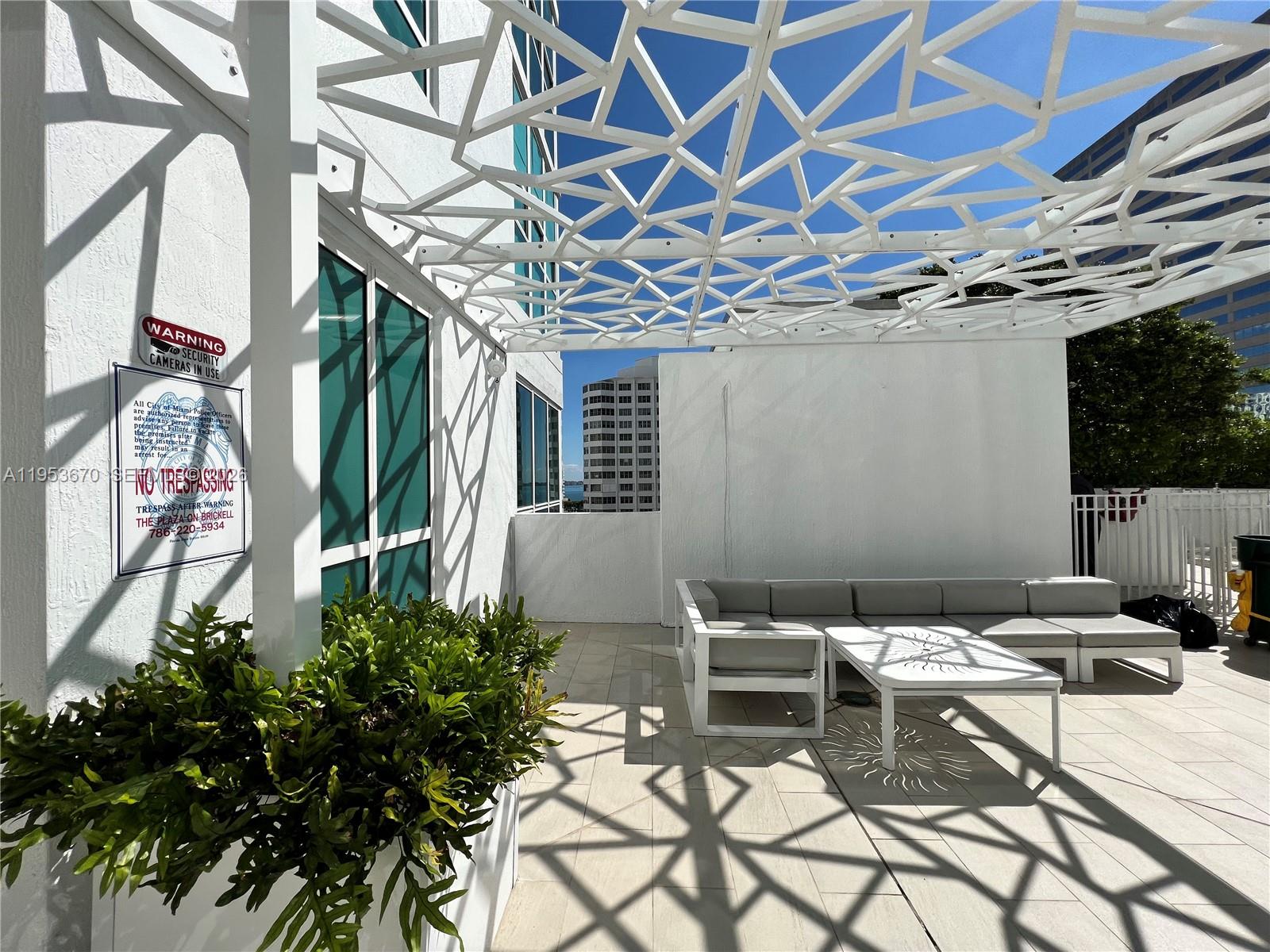951 Brickell Avenue, Unit 3304 Miami, FL 33131 - Photo 21 of 28 a view of a dinning table and chairs in patio