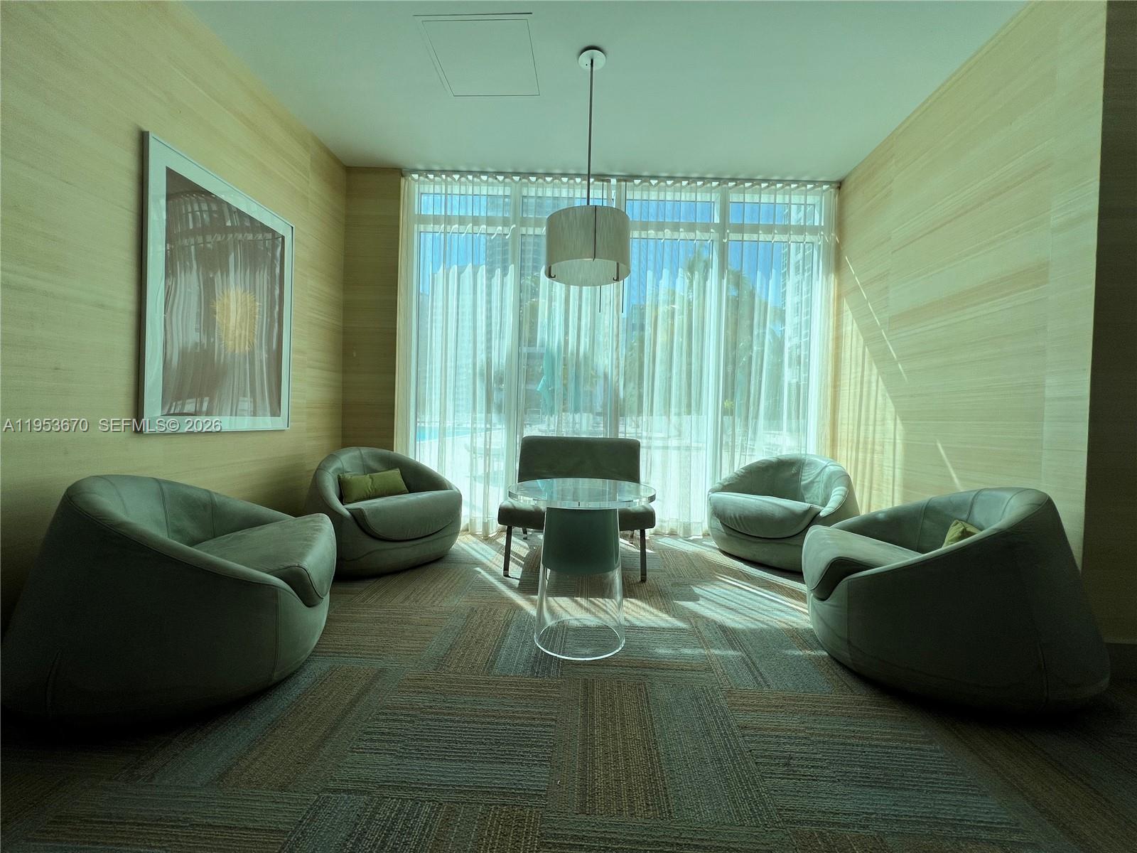 951 Brickell Avenue, Unit 3304 Miami, FL 33131 - Photo 27 of 28 a living room with furniture and a chandelier