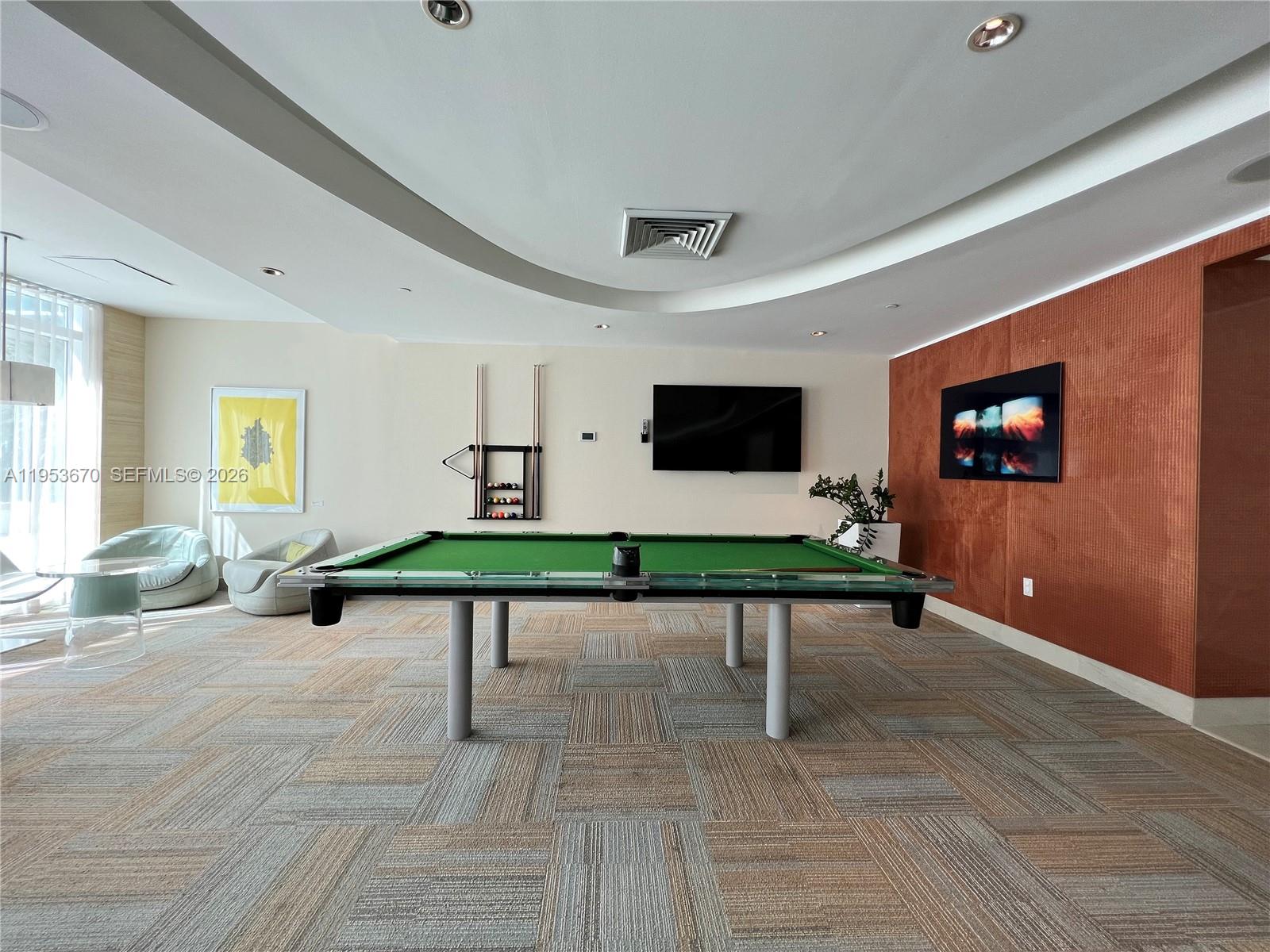 951 Brickell Avenue, Unit 3304 Miami, FL 33131 - Photo 28 of 28 a living room with furniture pool table and flat screen tv