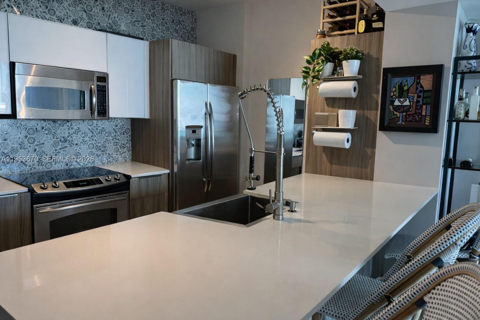 951 Brickell Avenue, Unit 3304 Miami, FL 33131 - Photo 6 of 28 a kitchen with a refrigerator and a stove top oven