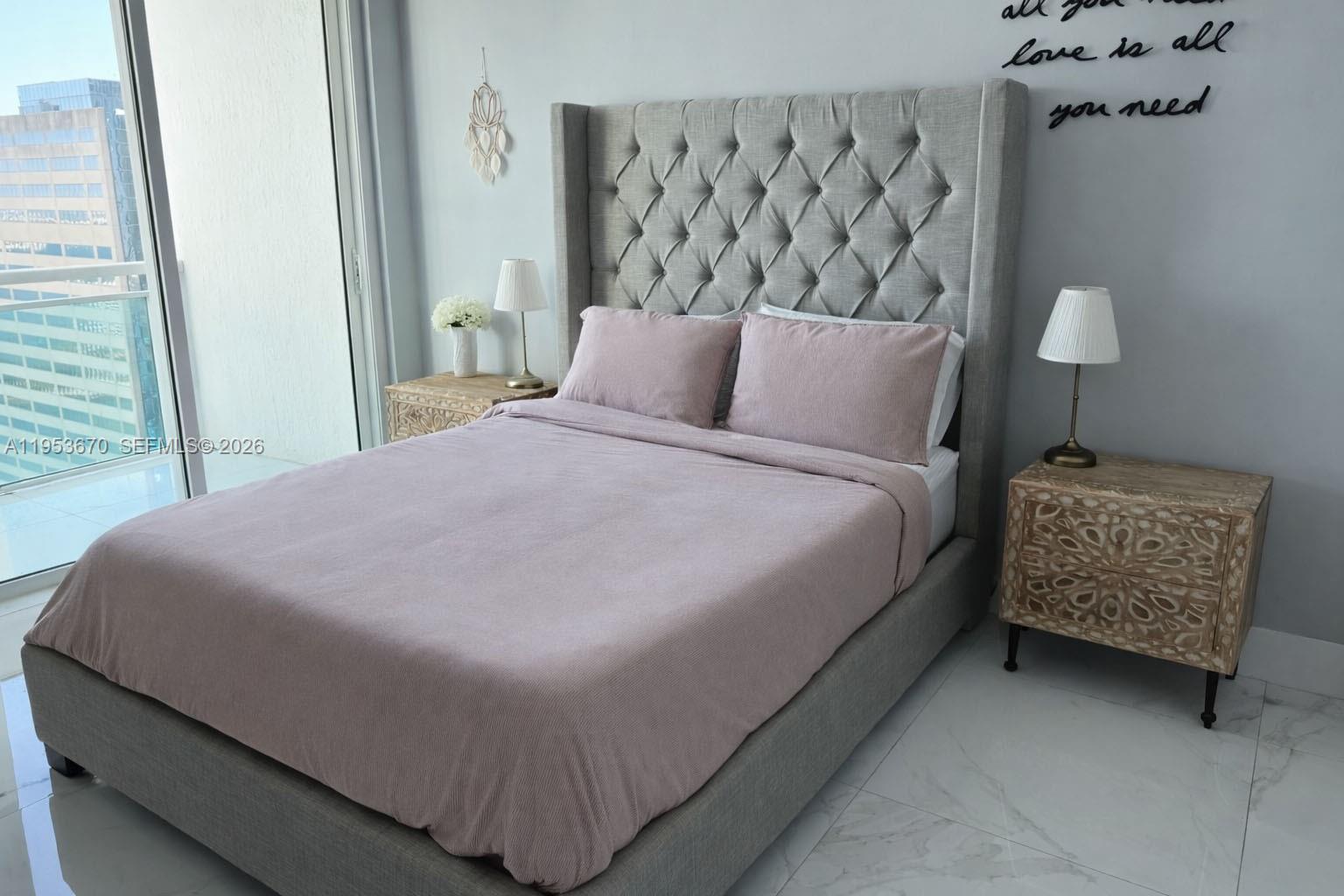 951 Brickell Avenue, Unit 3304 Miami, FL 33131 - Photo 8 of 28 a bed sitting in a bedroom next to a lamp