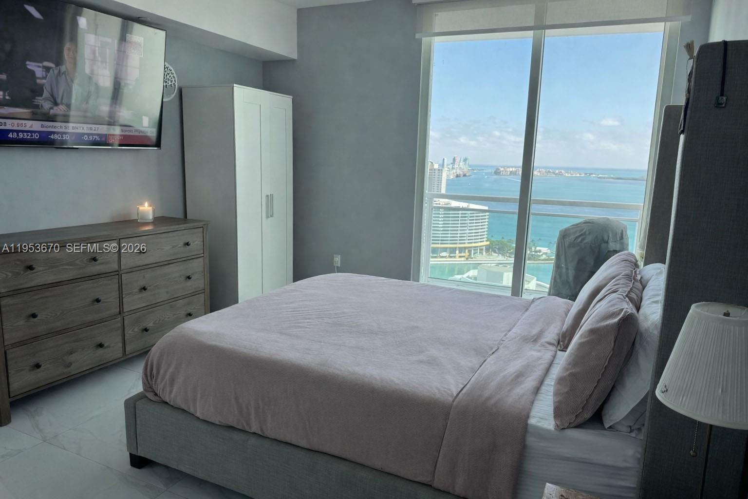 951 Brickell Avenue, Unit 3304 Miami, FL 33131 - Photo 9 of 28 a bedroom with a bed and window
