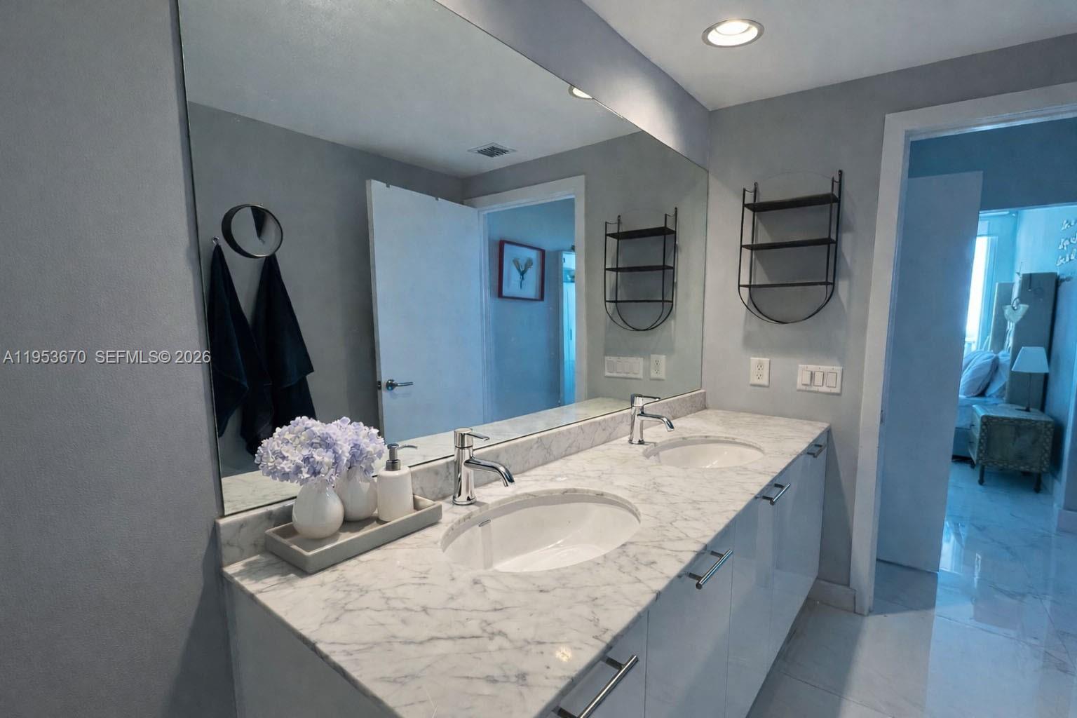 951 Brickell Avenue, Unit 3304 Miami, FL 33131 - Photo 10 of 28 a bathroom with a granite countertop sink and a mirror