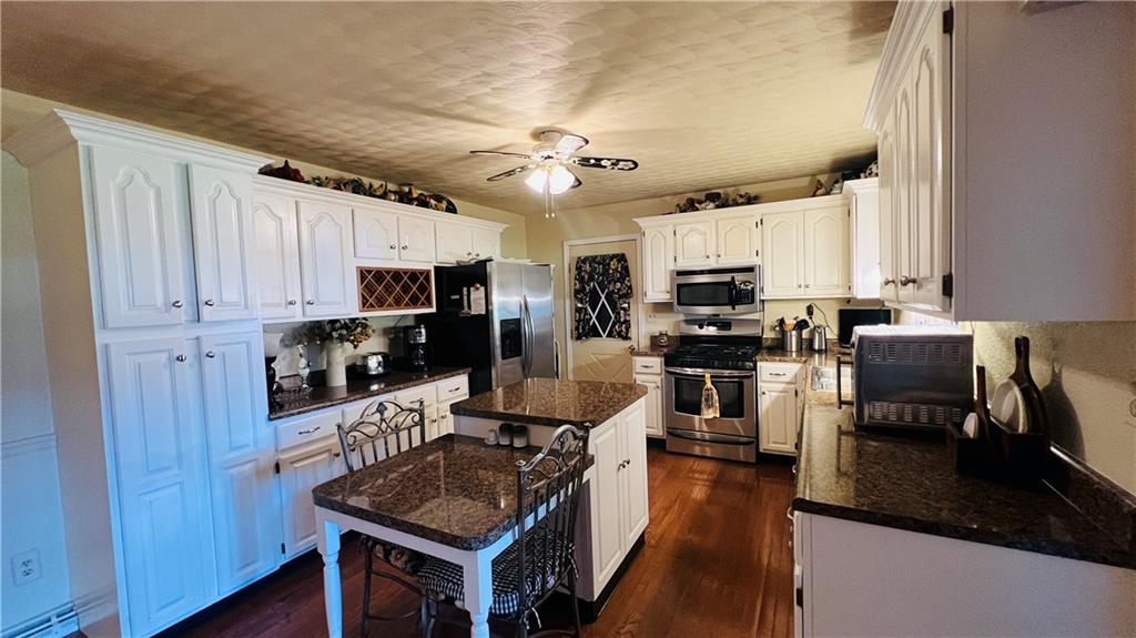 3356 Miola Road Clarion, PA 16214 - Photo 4 of 27 a kitchen with stainless steel appliances granite countertop a stove sink refrigerator and cabinets