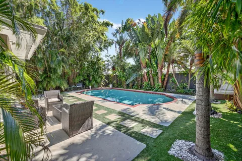 a view of a backyard with sitting area
