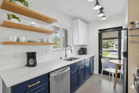 a kitchen with stainless steel appliances granite countertop a sink and cabinets