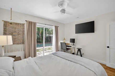 a view of a bedroom with a hardwood floor and a bathroom