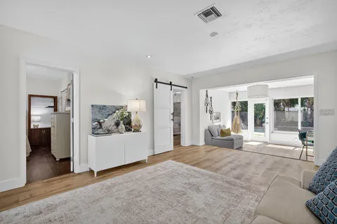 a living room with furniture and a wooden floor