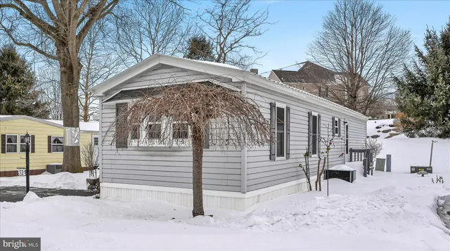 a view of a house with a snow in the yard