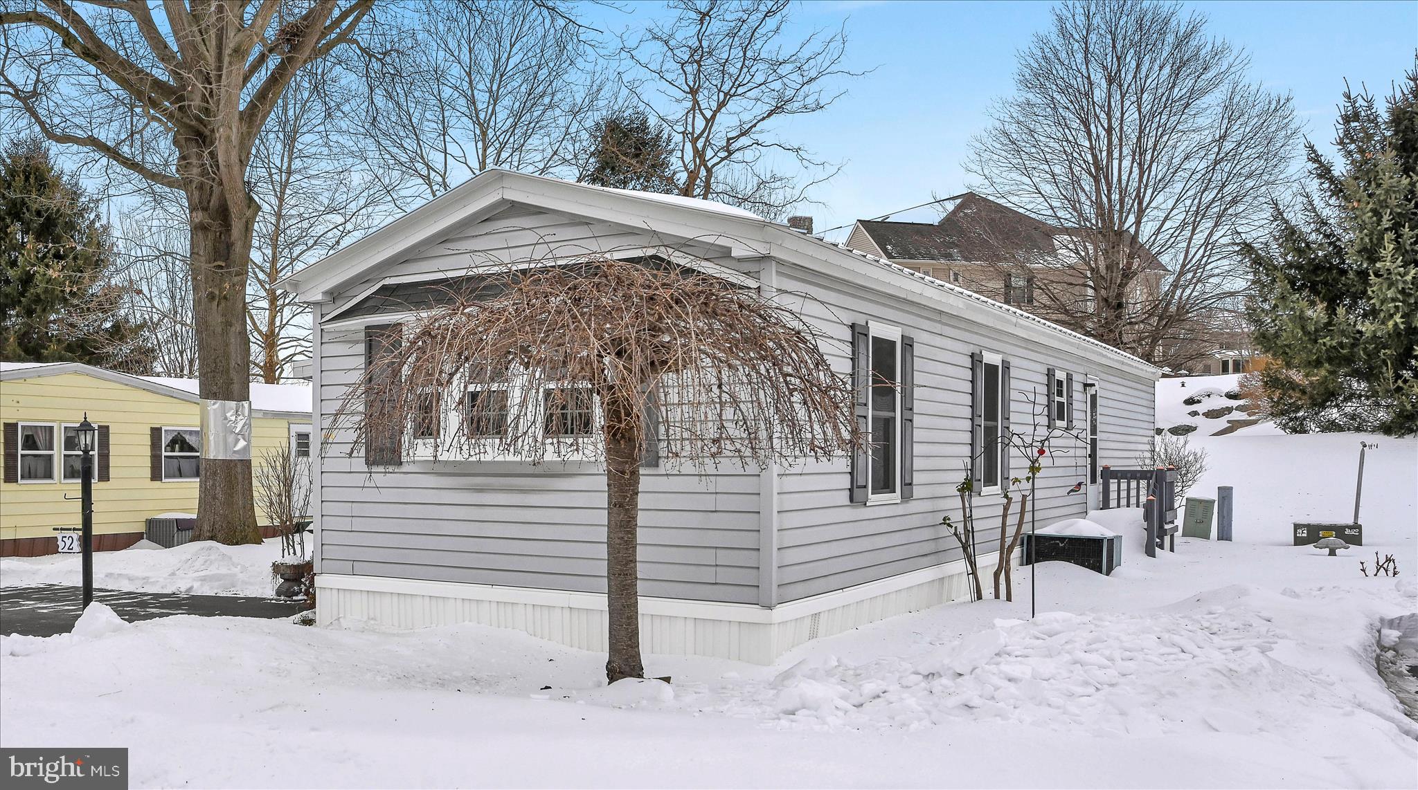 a view of a house with a snow in the yard