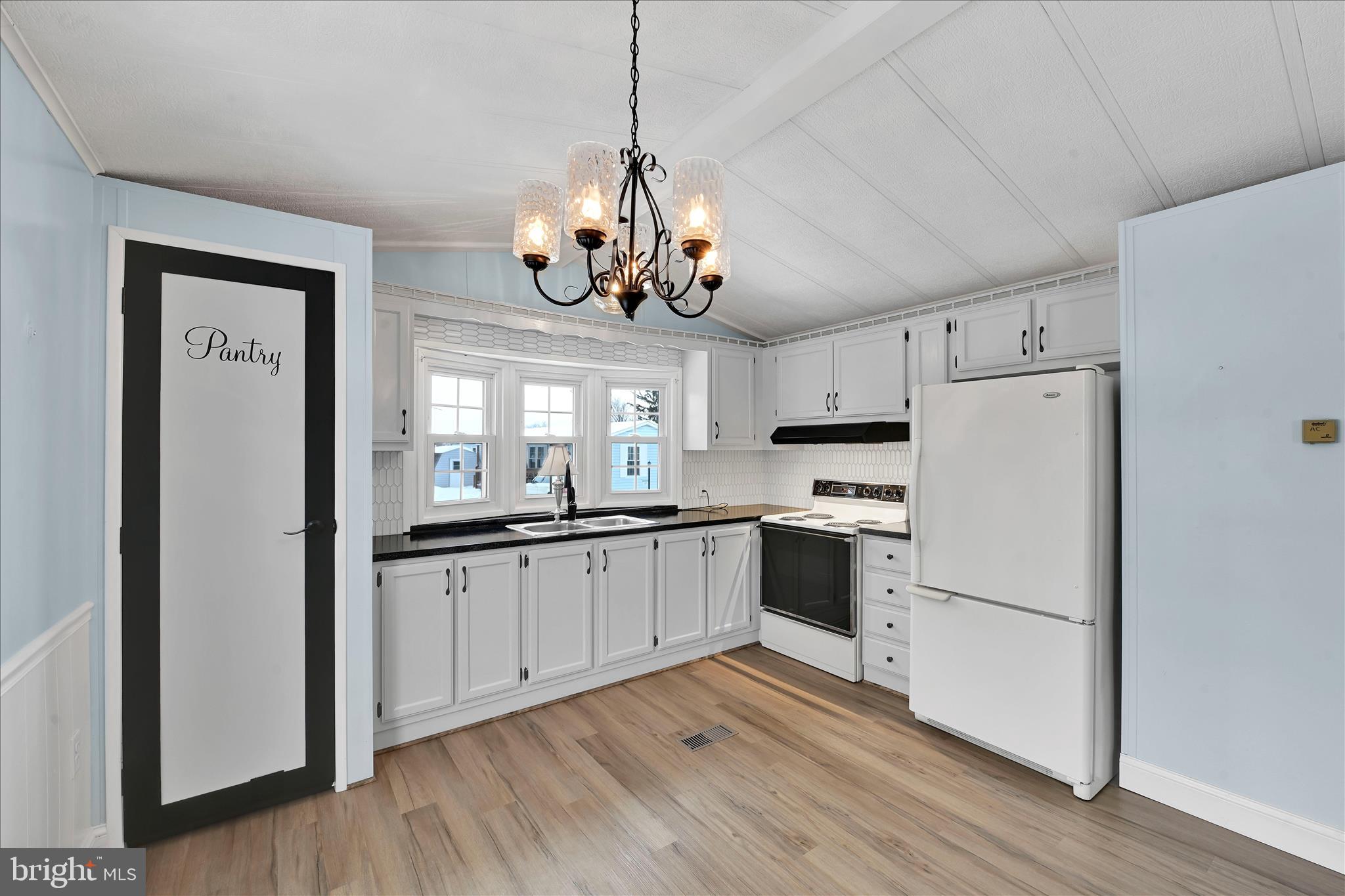 137 Meadow Valley Road Ephrata, PA 17522 - Photo 14 of 31 a kitchen with stainless steel appliances granite countertop a refrigerator a sink dishwasher a stove and white cabinets with wooden floor