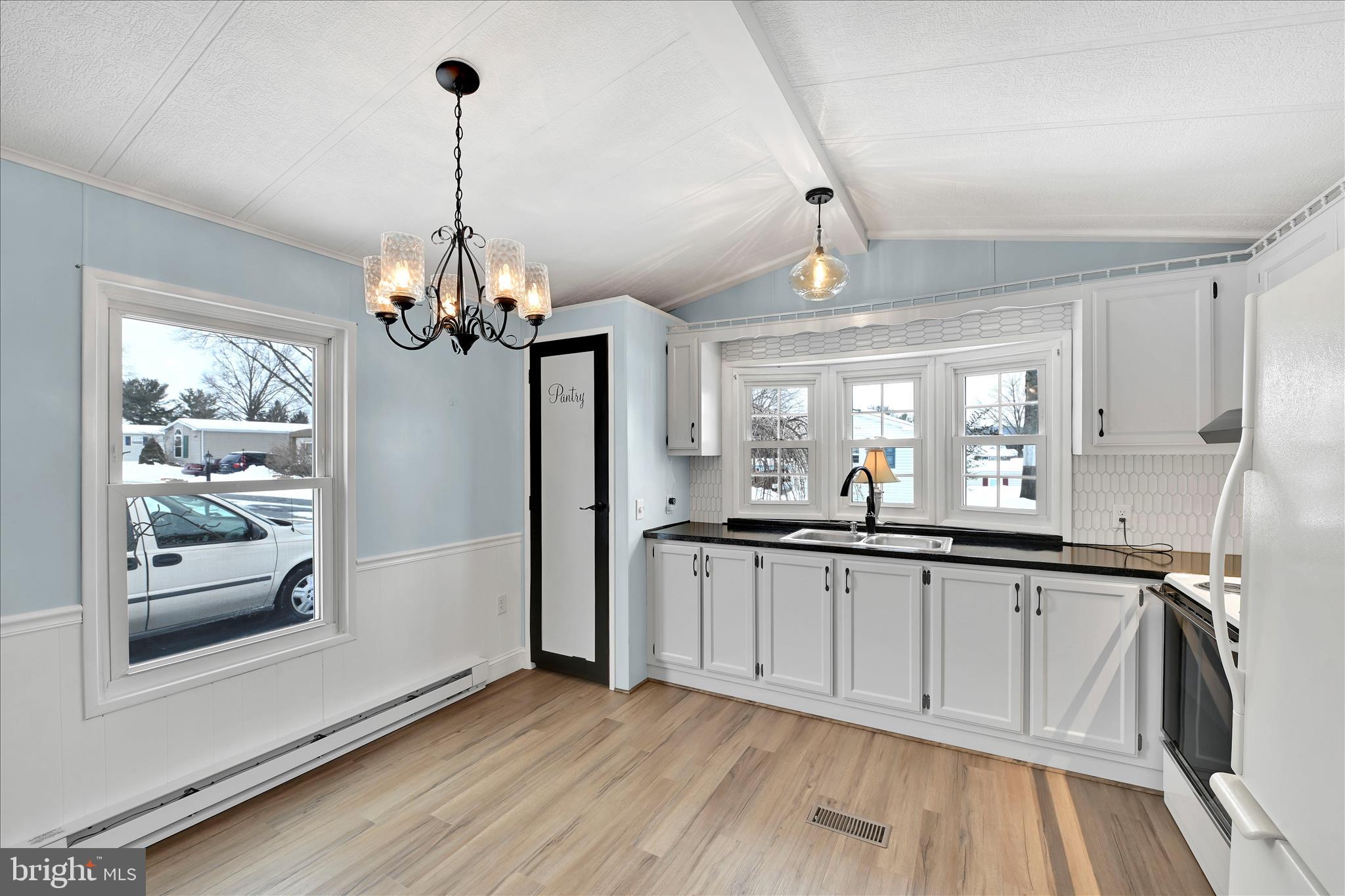 137 Meadow Valley Road Ephrata, PA 17522 - Photo 15 of 31 a kitchen with stainless steel appliances granite countertop a refrigerator a sink dishwasher a stove and white cabinets with wooden floor