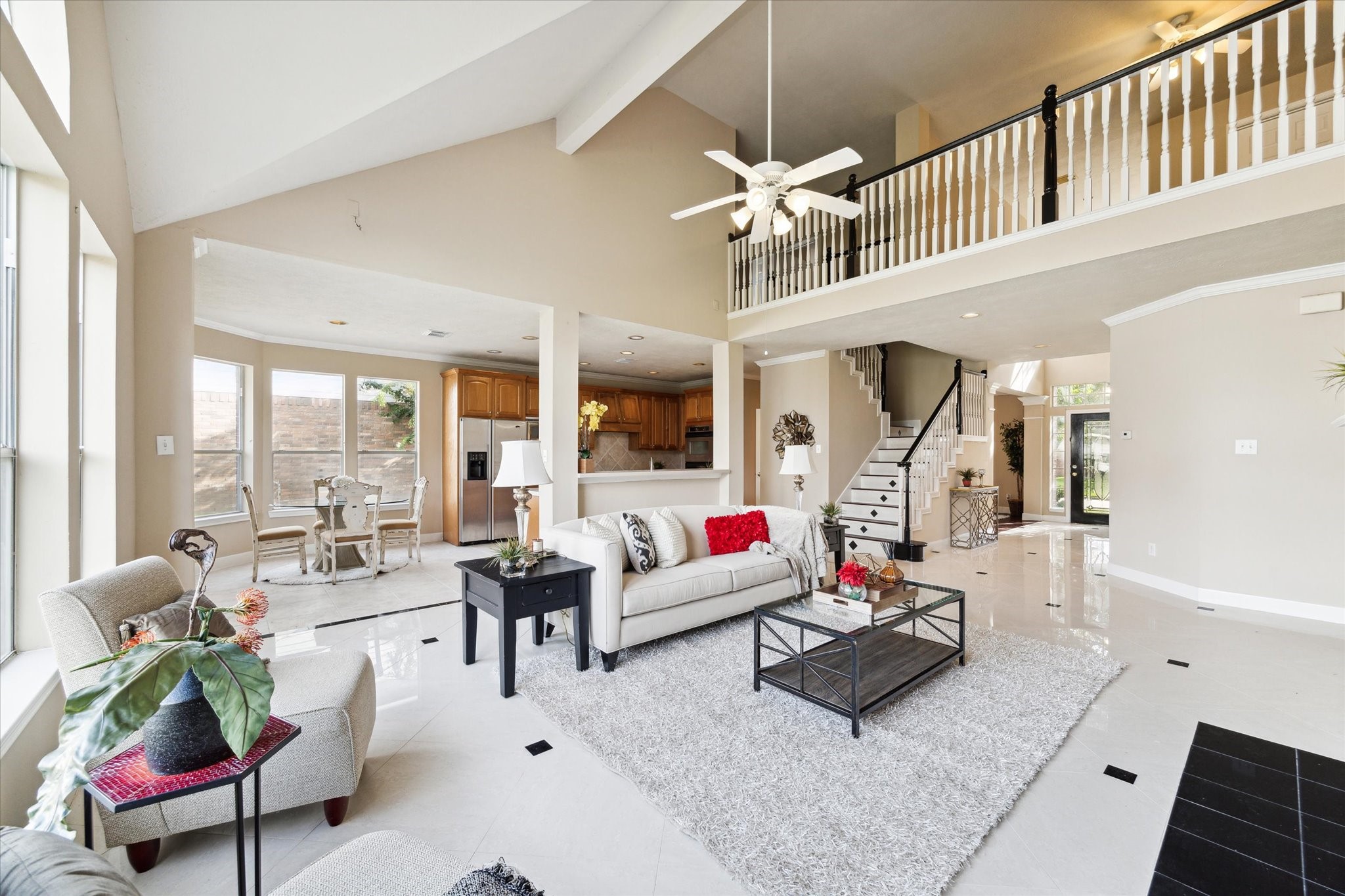 1818 Cross Spring Drive Sugar Land, TX 77479 - Photo 11 of 32 a living room with furniture stairs and a chandelier