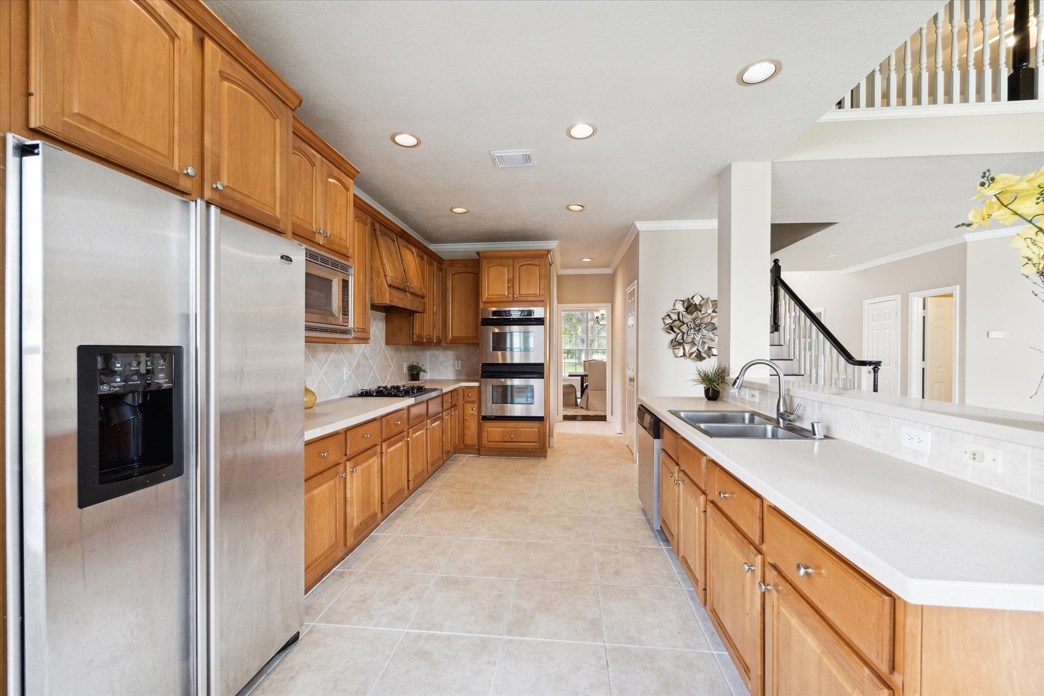 1818 Cross Spring Drive Sugar Land, TX 77479 - Photo 16 of 32 a large kitchen with stainless steel appliances kitchen island granite countertop a large counter top stainless steel appliances and cabinets