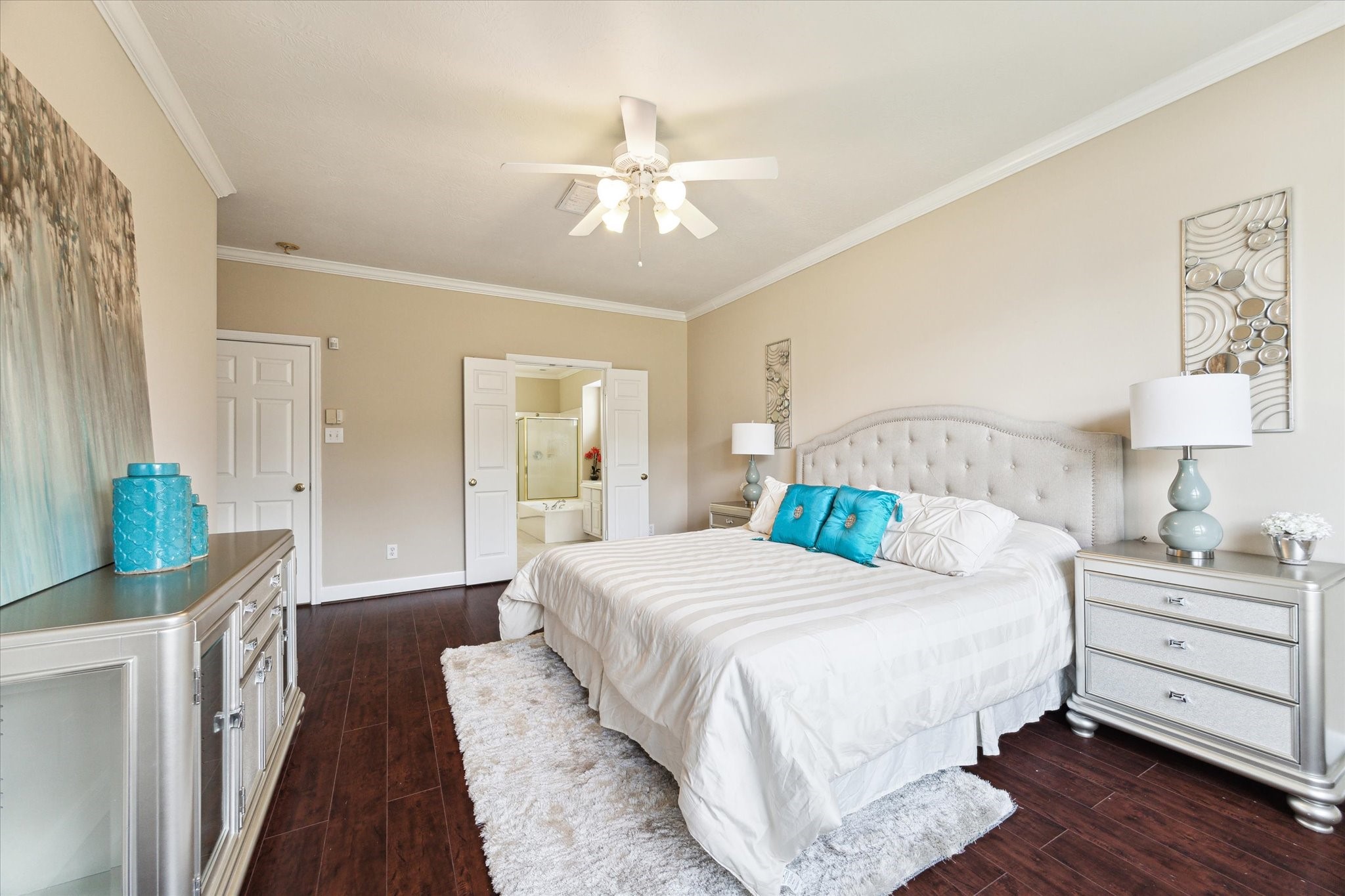 1818 Cross Spring Drive Sugar Land, TX 77479 - Photo 17 of 32 a bedroom with a bed and a chandelier