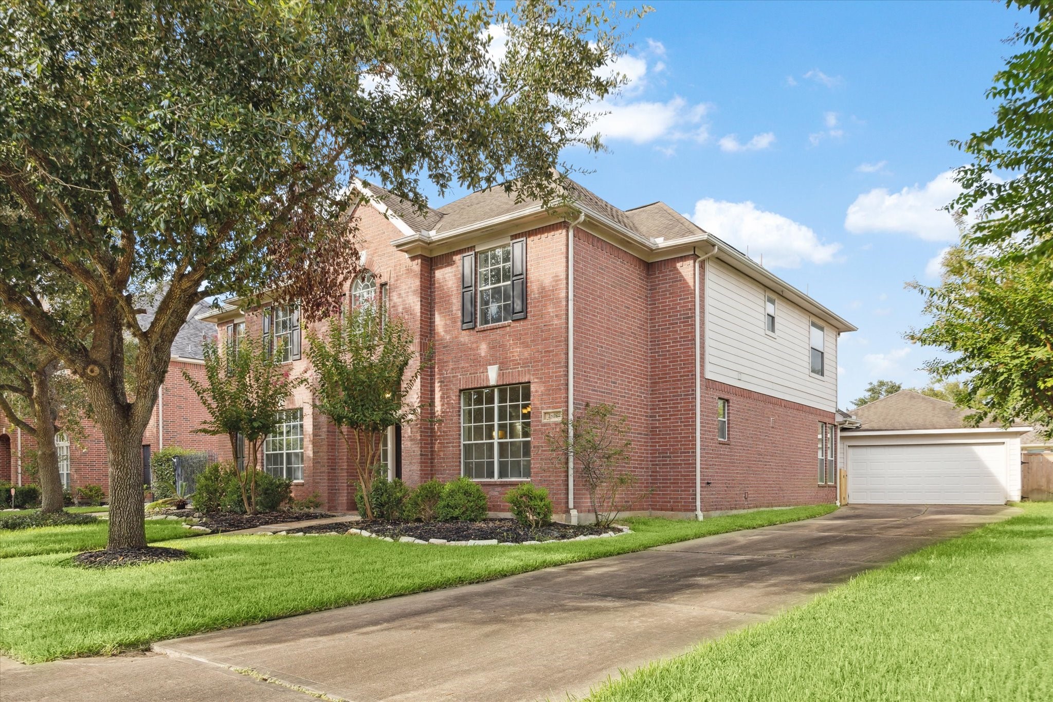 1818 Cross Spring Drive Sugar Land, TX 77479 - Photo 2 of 32 a front view of a house with a yard and garage