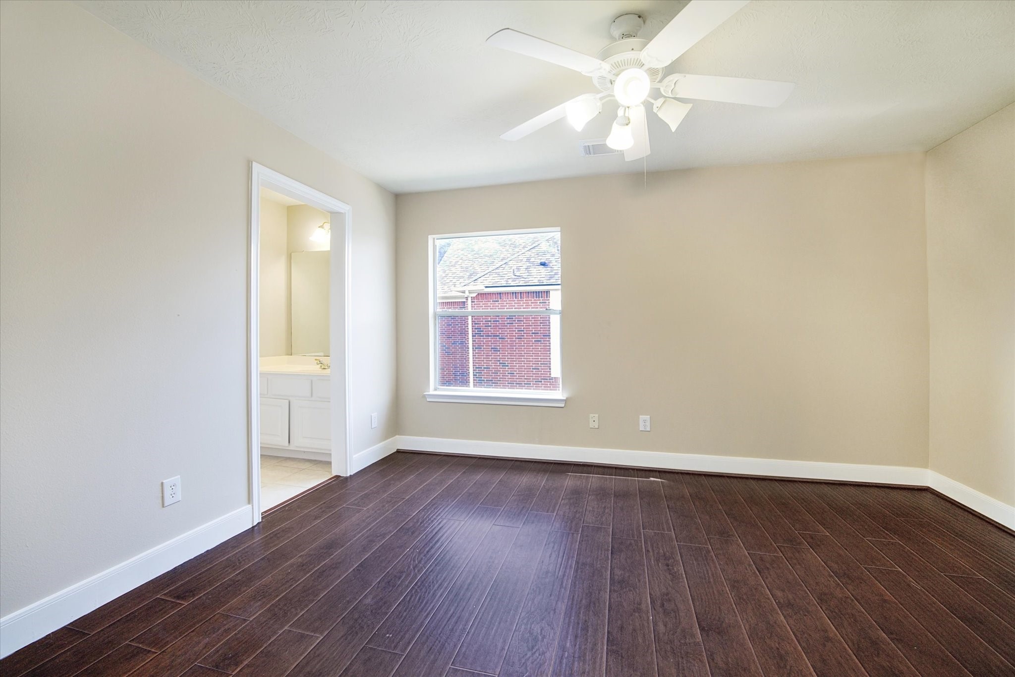 1818 Cross Spring Drive Sugar Land, TX 77479 - Photo 25 of 32 an empty room with wooden floor chandelier fan and windows