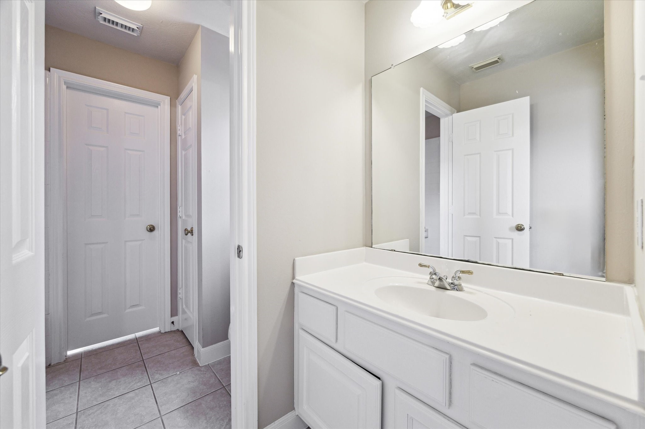 1818 Cross Spring Drive Sugar Land, TX 77479 - Photo 26 of 32 a bathroom with a sink and a mirror