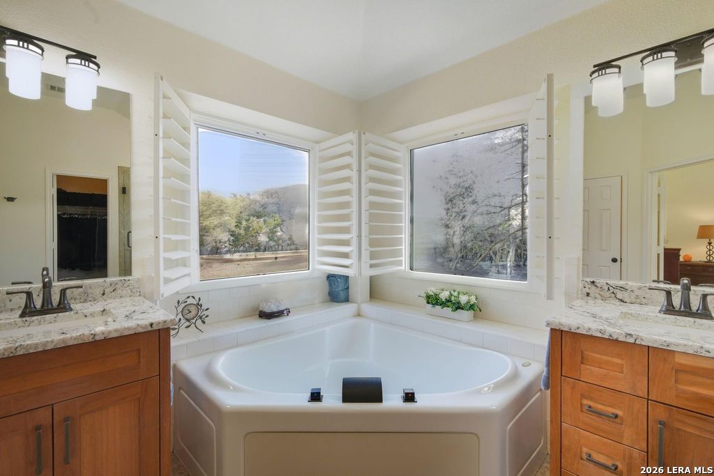 318 River Ridge Boerne, TX 78006 - Photo 22 of 46 a bathroom with a tub a sink and a window