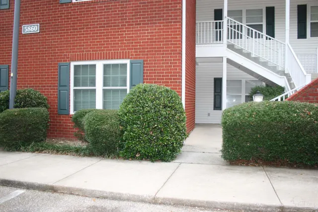 a view of house with brick walls