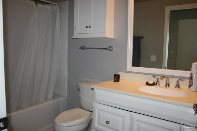 a bathroom with a toilet and a vanity