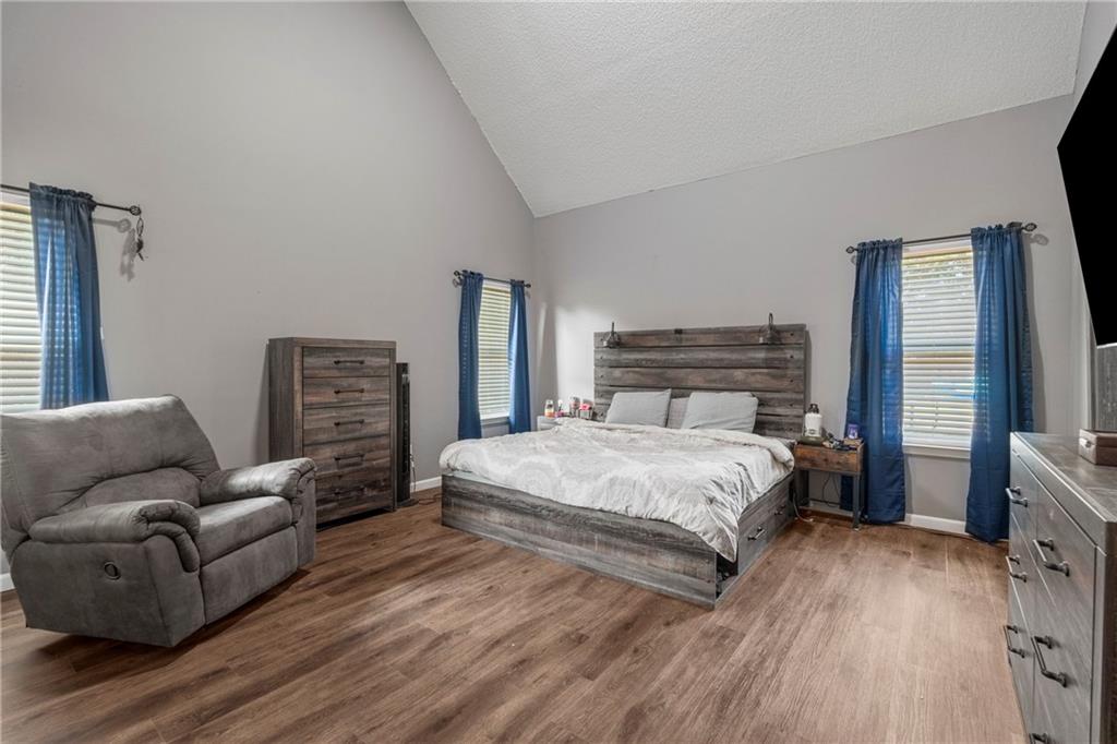 234 Owens Road Fort Mitchell, AL 36856 - Photo 12 of 25 Bedroom with wood finished floors, baseboards, and high vaulted ceiling