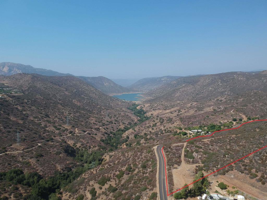 a view of a dry yard with mountains in the background