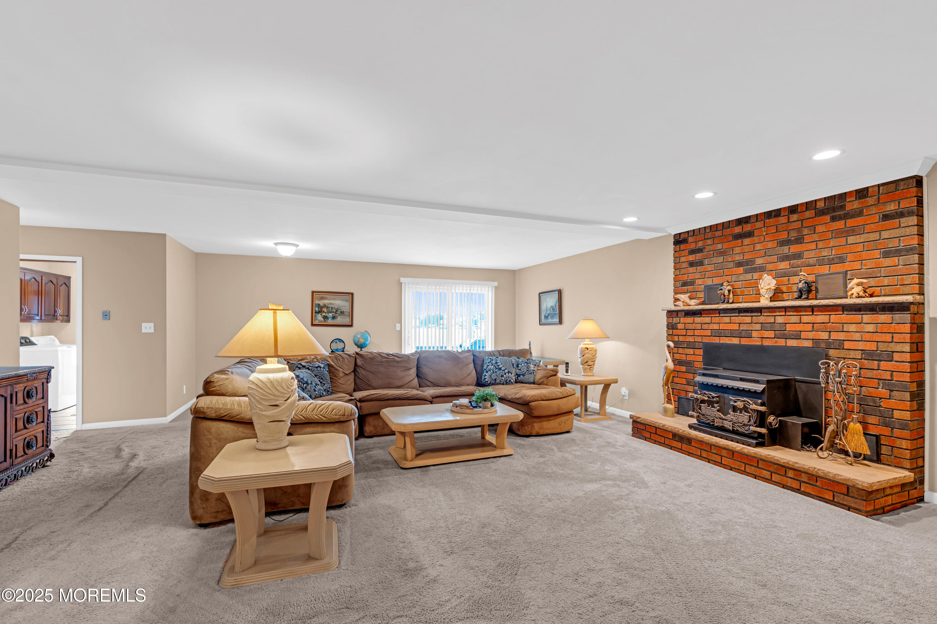 5 Bay Way Brick, NJ 08723 - Photo 18 of 61 a living room with furniture a fireplace and a flat screen tv