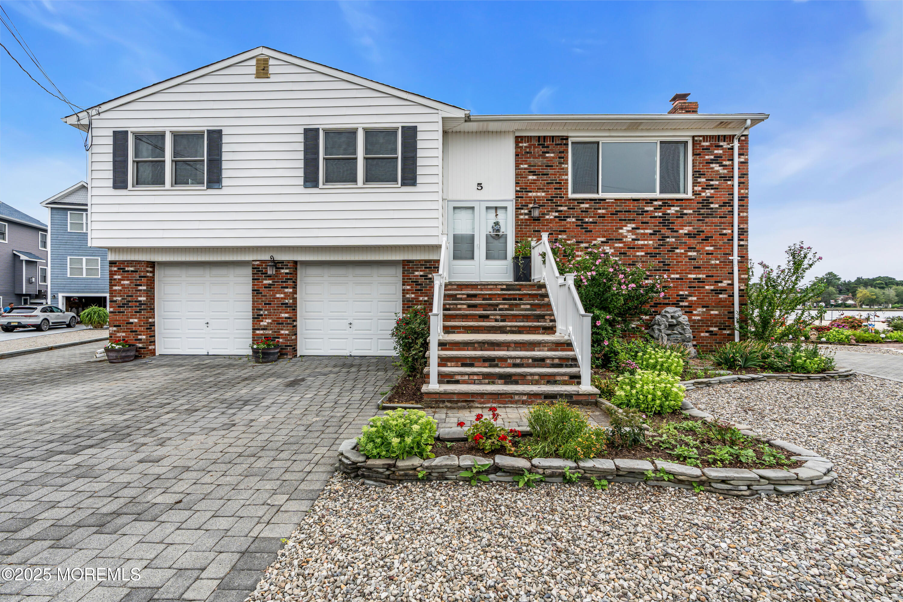 5 Bay Way Brick, NJ 08723 - Photo 2 of 61 a front view of a house with a yard and garage