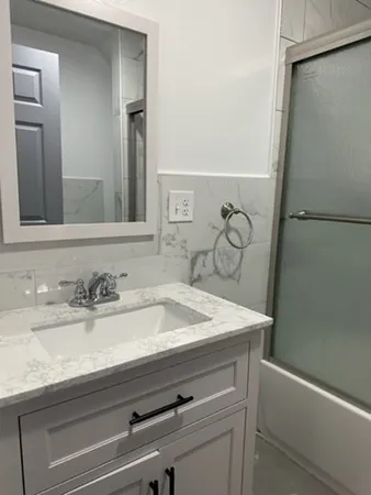 a bathroom with a sink and a mirror