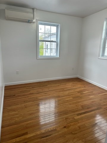 37 Cedar Street, Unit 1 Lawrence, MA 01841 - Photo 2 of 6 a view of an empty room with wooden floor and a window