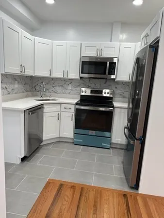 a kitchen with a sink stove and microwave