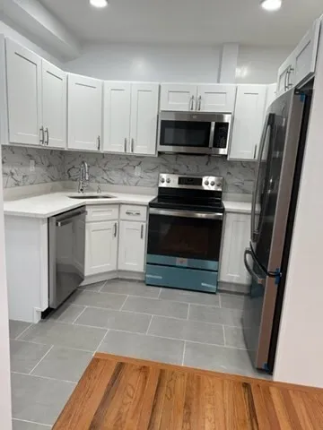 a kitchen with a sink stove and microwave