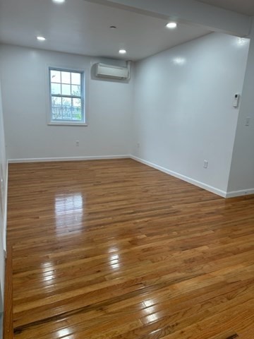 37 Cedar Street, Unit 1 Lawrence, MA 01841 - Photo 4 of 6 an empty room with wooden floor and windows