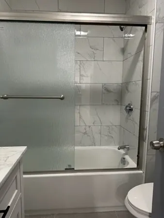 a bathroom with a shower and a bathtub