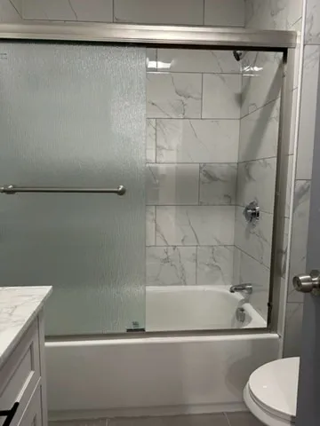 a bathroom with a shower and a bathtub