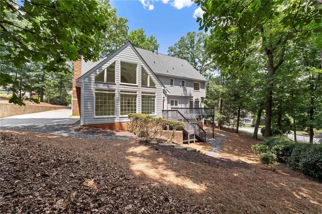 8965 Laurel Way Alpharetta, GA 30022 - Photo 58 of 79 a view of a house with a yard siting area and garden