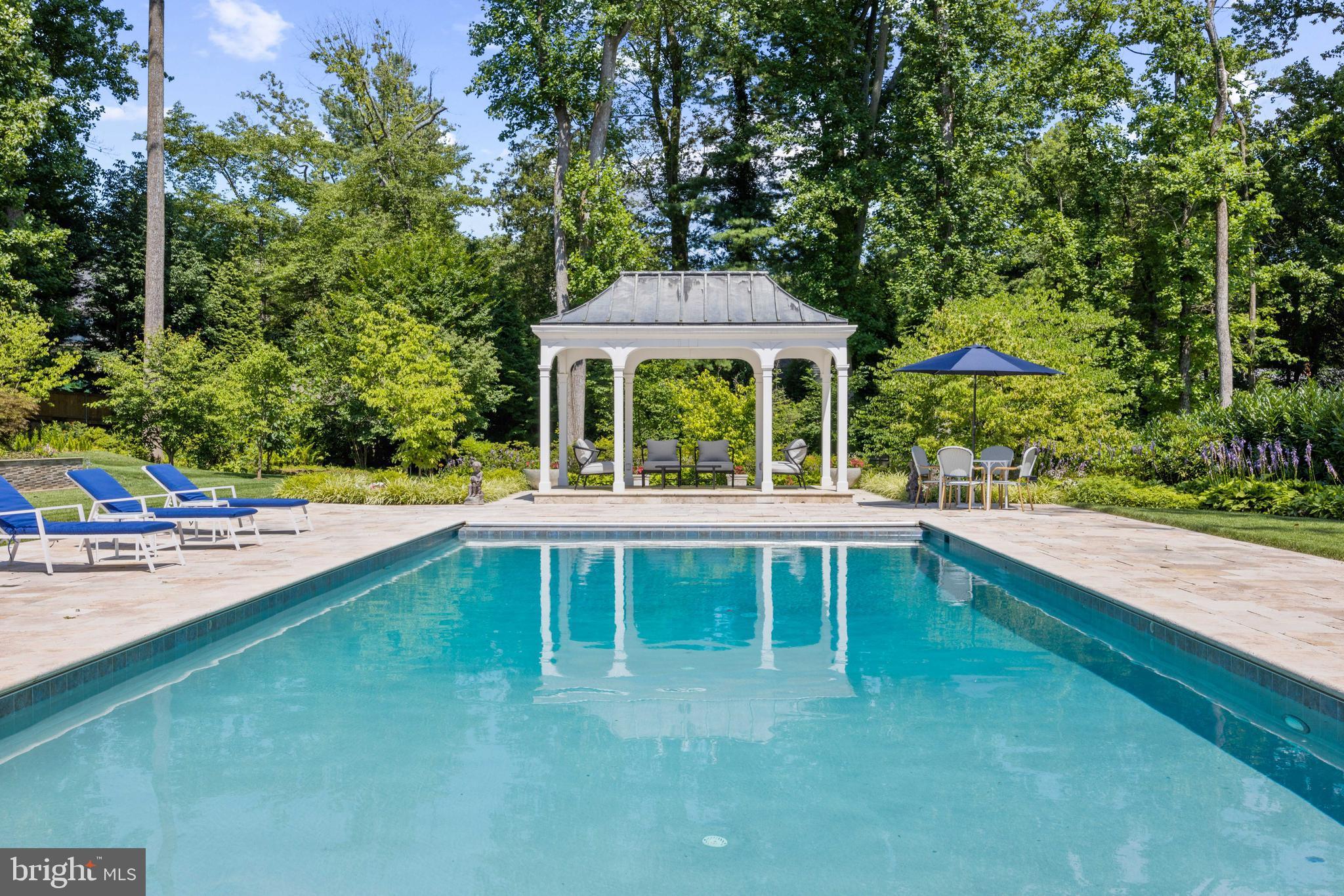 8801 Fernwood Road Bethesda, MD 20817 - Photo 40 of 48 a view of a house with pool and a yard