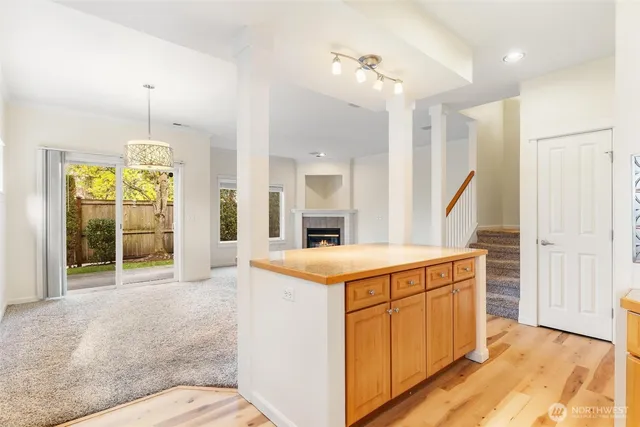 a view of a kitchen with cabinets and wooden floor
