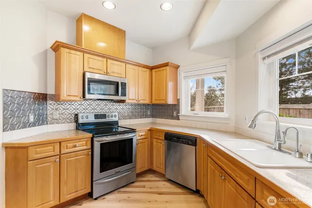 a kitchen with a sink stove and microwave